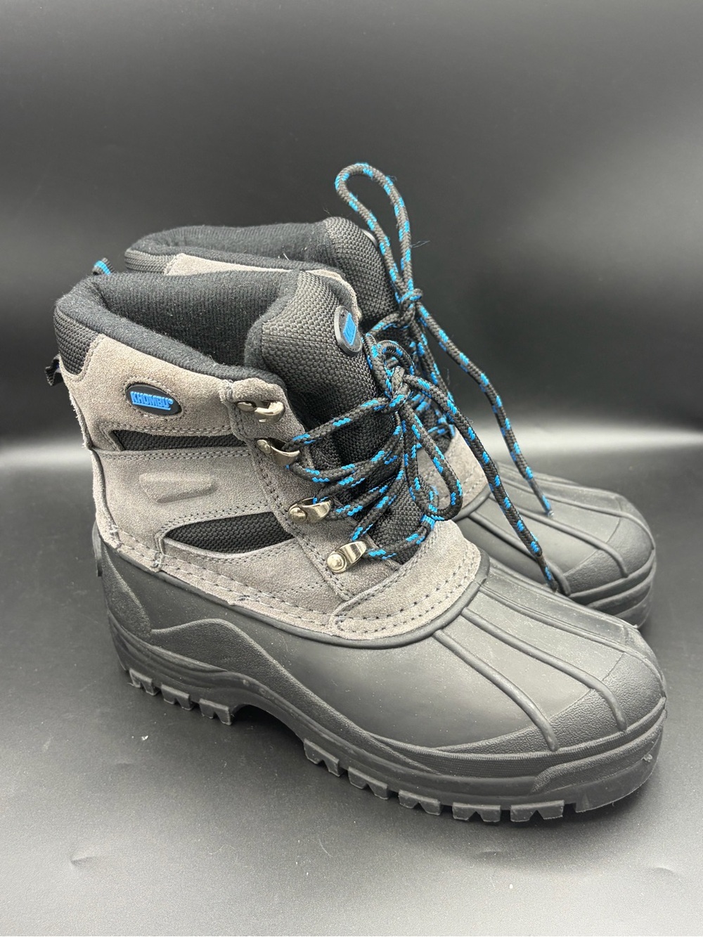 Khombu weather-rated duck boots featuring blue-accented laces size 4